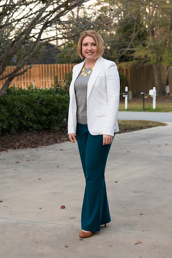 Business outfit with bright necklace to draw the eye up and away from wide hips.