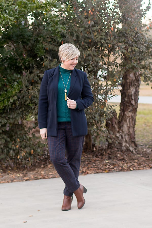 women's winter office outfit with plaid pants, sweater, and ankle boots