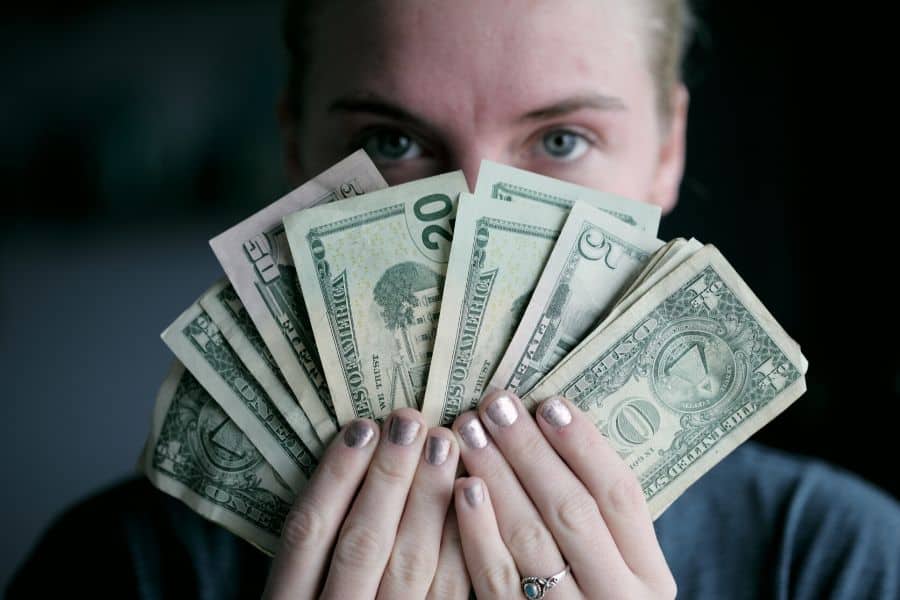 woman holding up money