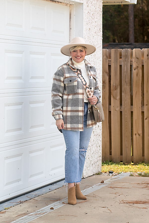 shacket outfit with wide brim hat and light wash jeans